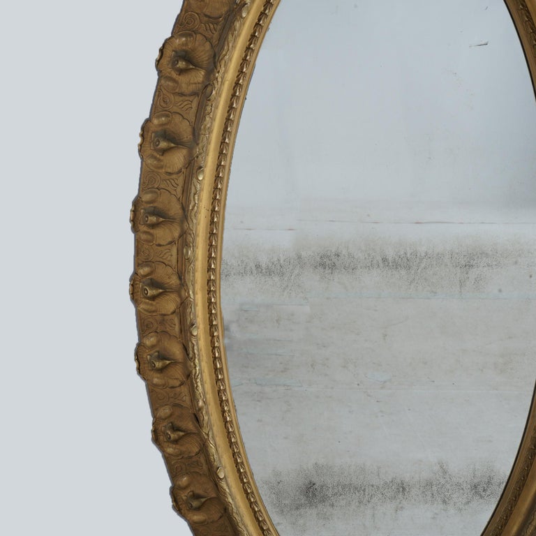 Oversized Gold Giltwood Oval Parlor Mirror with Foliate & Floral Crest C1890