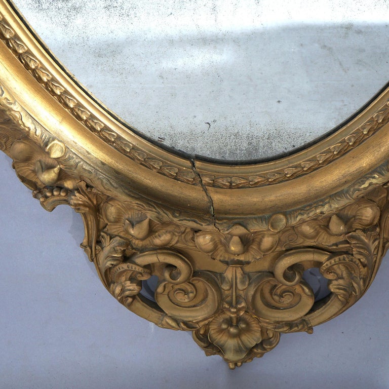 Oversized Gold Giltwood Oval Parlor Mirror with Foliate & Floral Crest C1890