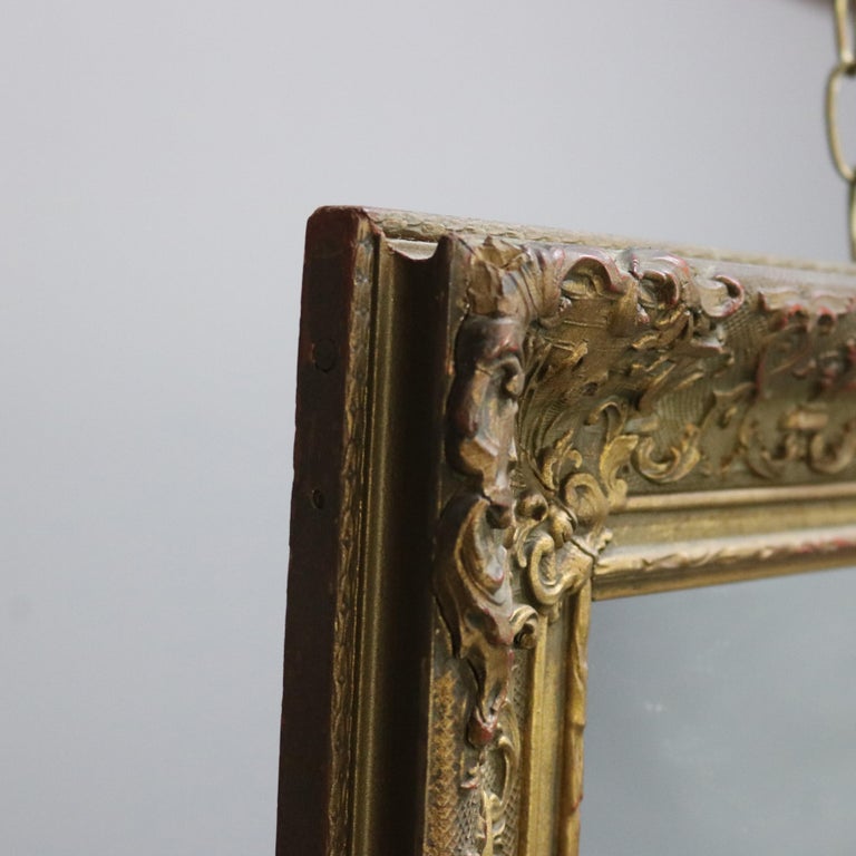 Antique Continental Scroll and Foliate Giltwood Framed Wall Mirror, circa 1900