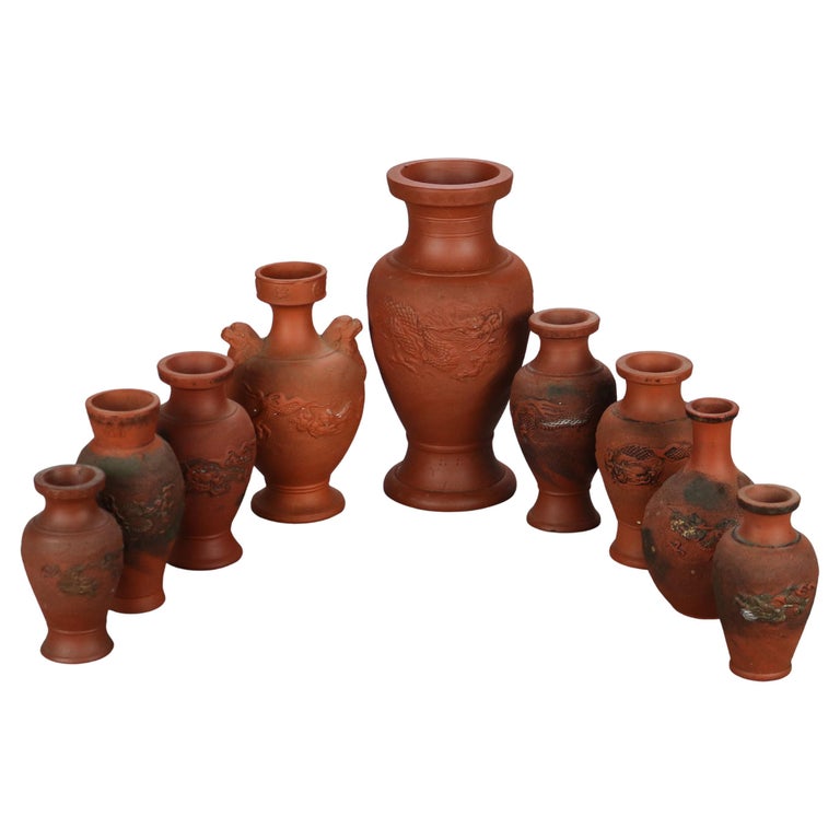 Nine Japanese Embossed Terra Cotta Vases C1930